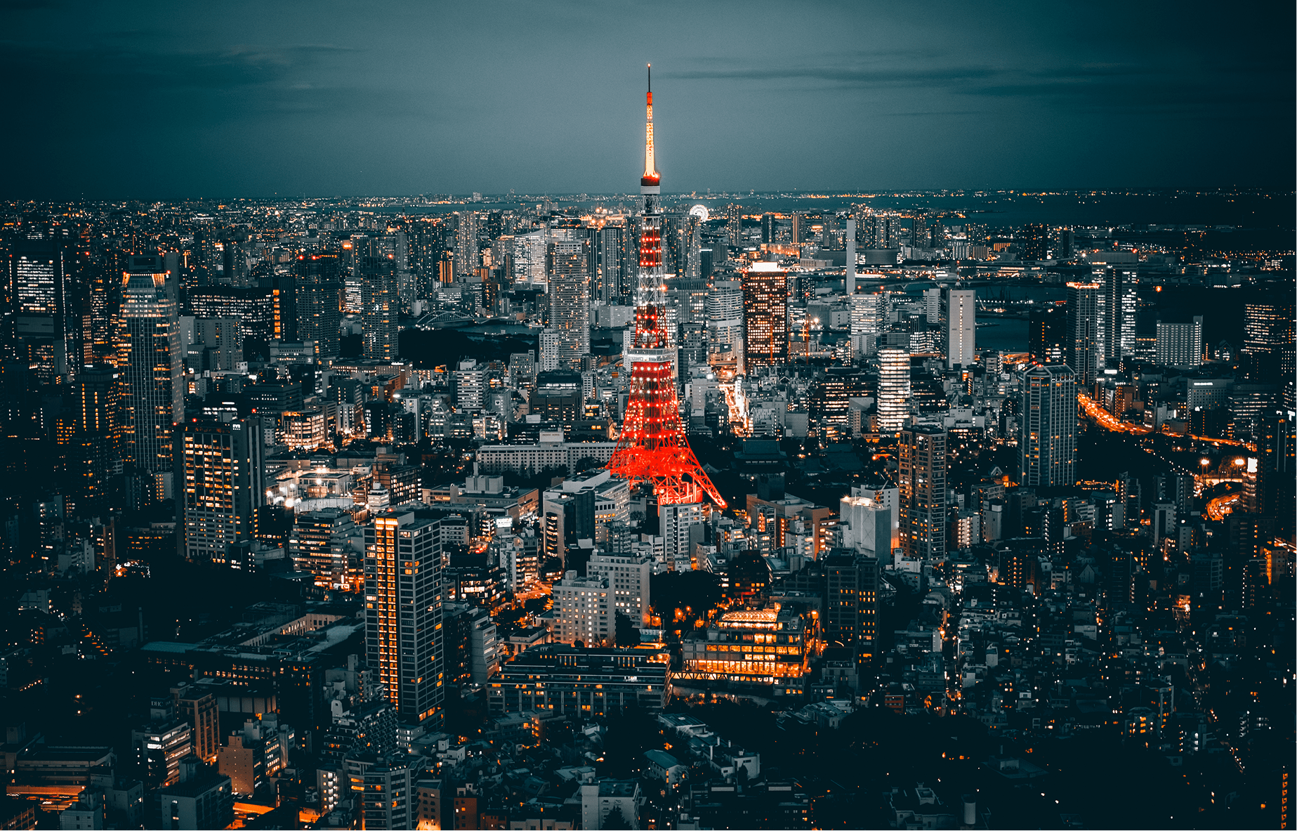 illuminated-tokyo-tower-amidst-buildings-city-against-sky 2-min