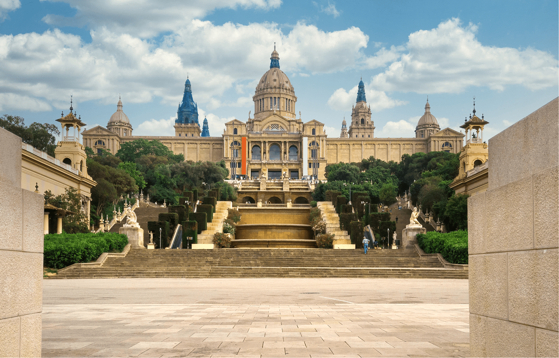 palau-national-barcelona-spain-gardens-people-front-it-cloudy-sky-min